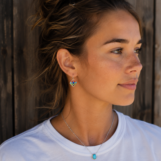 Woman wearing handmade sterling silver colorful agate drop earrings